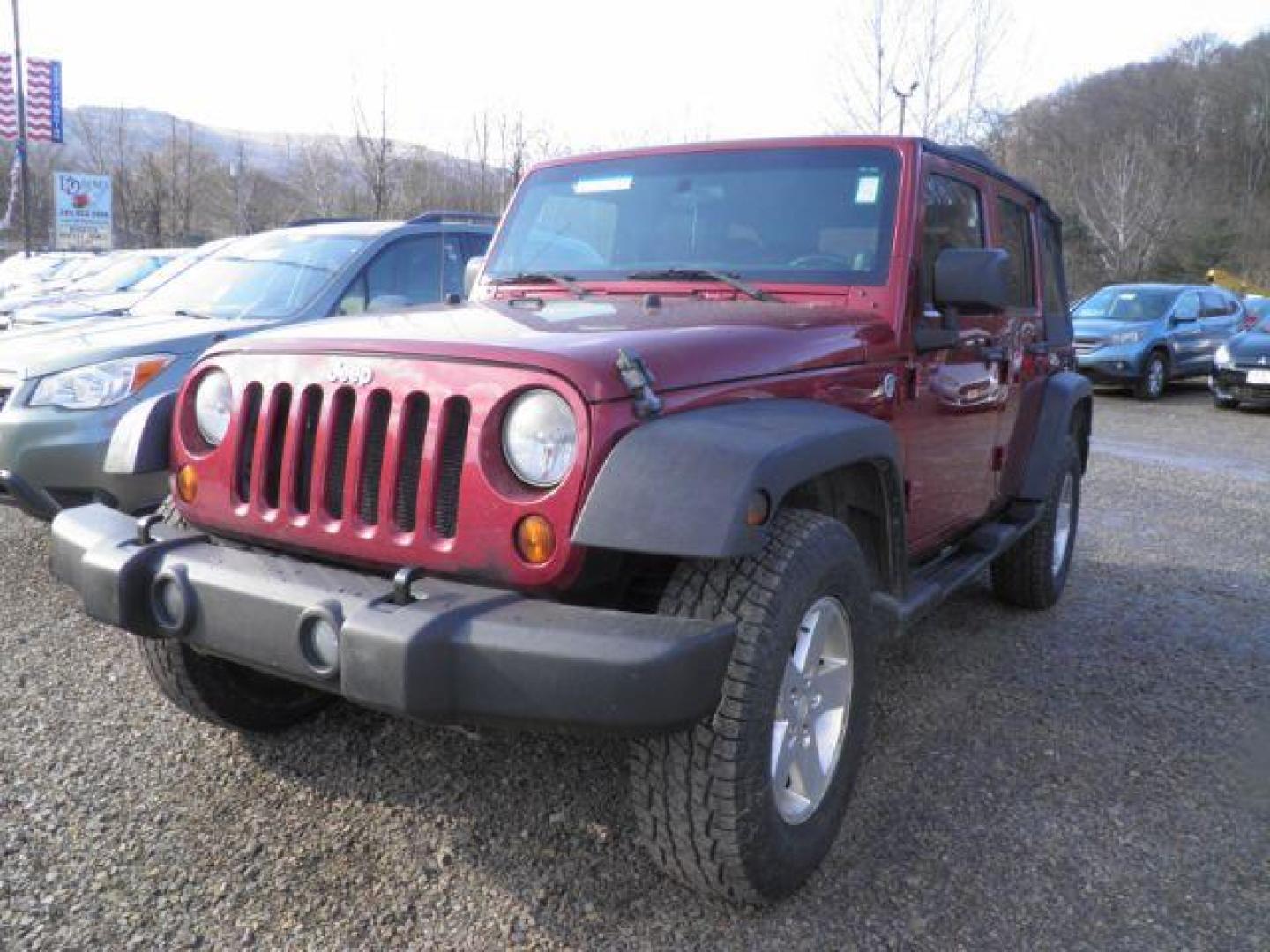 2012 RED Jeep Wrangler Unlimited Sport 4WD (1C4BJWDG6CL) with an 3.6L V6 engine, 6SP transmission, located at 19521 New George's Creek Rd SW, Barton, MD, 21521, (301) 463-2404, 39.524323, -79.017906 - Photo#0