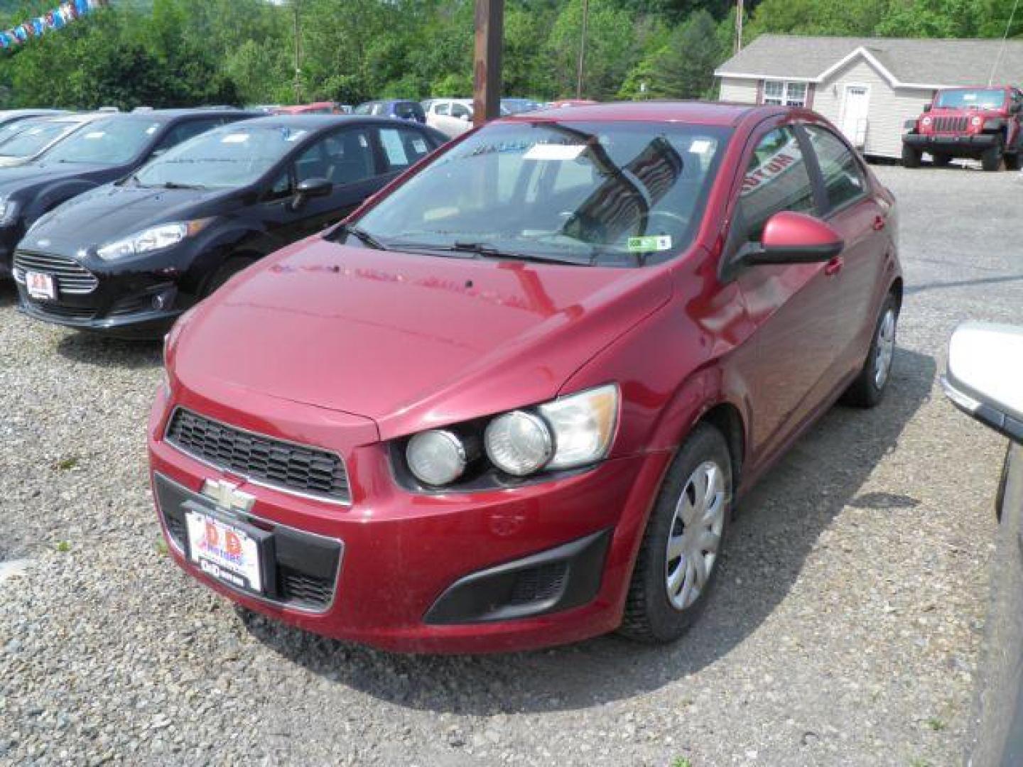 2014 Red Chevrolet Sonic LS Manual Sedan (1G1JB5SH5E4) with an 1.8L I4 engine, MAN transmission, located at 19521 New George's Creek Rd SW, Barton, MD, 21521, (301) 463-2404, 39.524323, -79.017906 - Photo#0